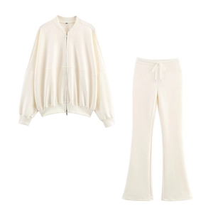 Flat lay of cream two-piece set featuring zip-up jacket and high-waisted flare pants