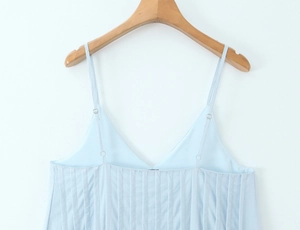 Detail view of light blue camisole top with V-neck, pleated texture and adjustable straps