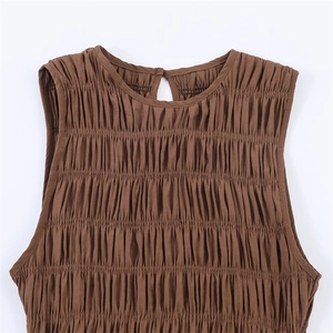 Detail of a brown sleeveless top featuring fine pleats, round neck, and back button closure