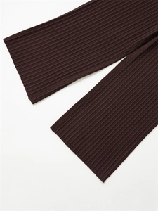 Close-up detail of dark brown ribbed knit fabric showing premium texture and vertical patterns