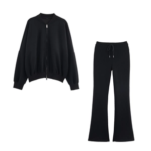 Flat lay of women's black tracksuit featuring high-collar jacket and flared pants set
