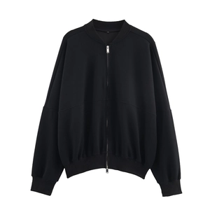 Close-up of black zip-up bomber jacket with ribbed cuffs and oversized silhouette