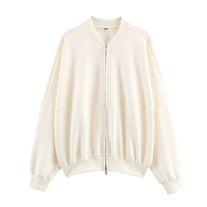 Detail of cream zip-up sweatshirt featuring ribbed cuffs and silver metal zipper closure
