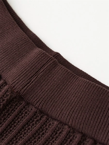 Detailed macro view of the dark brown ribbed knit fabric texture on the casual two-piece set