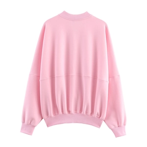Close-up of pink crewneck sweatshirt featuring dropped shoulders and ribbed cuffs