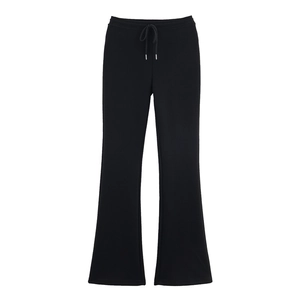 Detail of black drawstring flare pants featuring elastic waistband and soft knit fabric