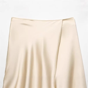 Elegant champagne satin midi skirt with side slit and smooth glossy finish for women