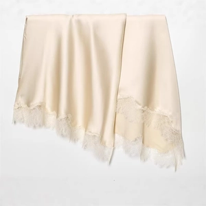 Champagne satin dress with delicate eyelash lace trim showing smooth silk texture