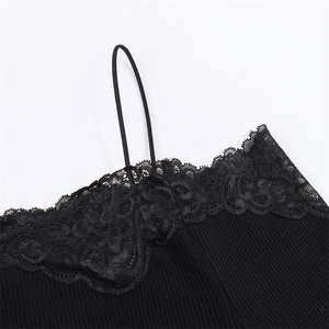 Detail of ribbed knit fabric texture and floral lace trim on a black camisole top