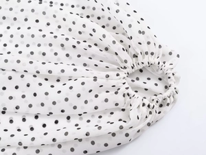 Détail de la manche à pois avec poignet élastique et texture de tissu léger