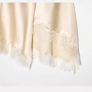 Elegant champagne satin dress with eyelash lace trim and irregular slit hem detail