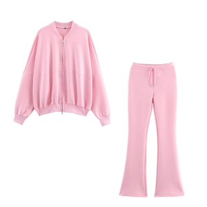 Pink two-piece loungewear set with zip-up jacket and flare pants in soft cotton blend