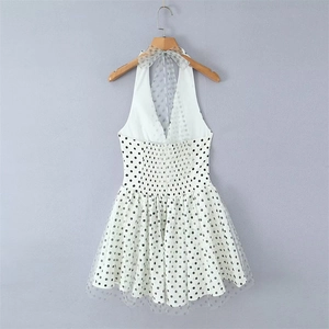 Detail of polka dot mesh halter dress showing V-neck and bow tie ribbon on hanger