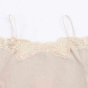 Detail of delicate floral lace trim on beige ribbed knit camisole top neckline