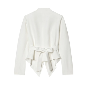Detail view of white blazer featuring elegant back tie bow and asymmetrical peplum hemline