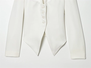 Detail of white blazer with four-button closure and unique pointed asymmetric hemline