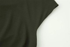 Detailed macro view of olive green layered dress showing premium textured chiffon fabric