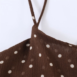 Macro shot of brown polka dot chiffon fabric with fine pleated texture and thin straps