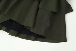 Detail of dark green ruffled chiffon layers with a comfortable black inner lining