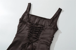 Detail of corset-style back with lace-up ties and boning on a chocolate brown dress