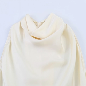 Detail view of cream cowl neck dress featuring premium satin fabric and invisible zipper