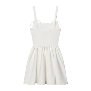 Detailed close-up of a white A-line mini dress with layered tulle and pleats