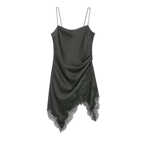 Close-up of black satin dress featuring a delicate eyelash lace trim and asymmetric hemline