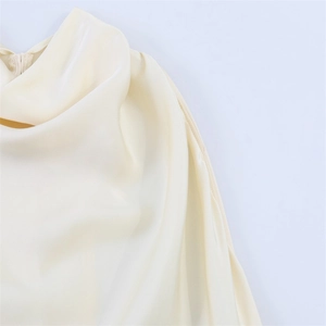 Detail of elegant ivory satin dress showing soft cowl neckline and hidden zipper closure
