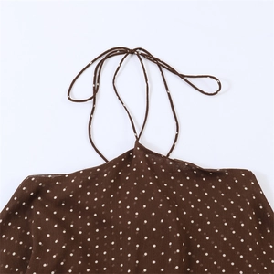 Brown polka dot halter neck dress with neck tie details and lightweight fabric texture