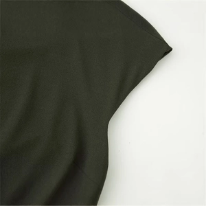 Fashionable dark green layered dress featuring premium textured fabric and shoulder details