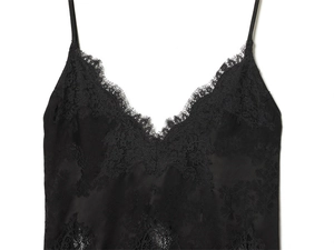 Detailed close-up of the delicate eyelash lace trim and V-neckline on a black lace top