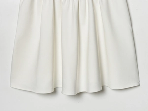 Detail shot of the pleated white mesh fabric layers showing fine woven texture