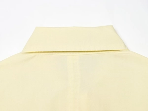 Close-up of the polo collar and fine stitching on this cream poplin shirt for women