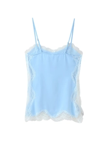 Detail of light blue lace camisole showing delicate white floral embroidery and adjustable strap