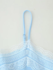 Detail of light blue camisole with delicate white lace trim and adjustable thin straps