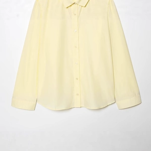 Women's light yellow long sleeve poplin polo shirt with single-breasted button closure