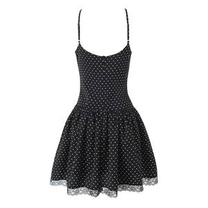 Detailed view of polka dot dress featuring slim straps and delicate black lace hem