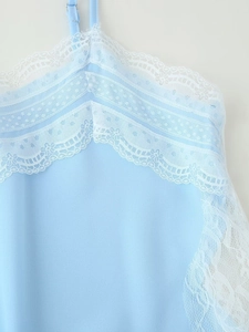Detail of light blue camisole featuring white floral lace V-neckline and sheer mesh embroidery