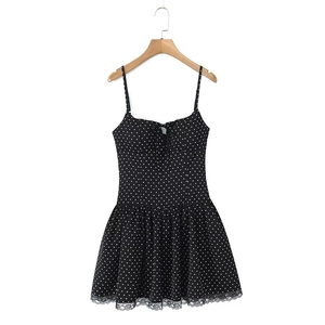 Detailed view of polka dot dress with drawstring bow and delicate lace hemline