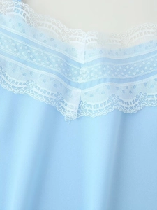Close-up of light blue summer top featuring exquisite triple-layered white lace detailing