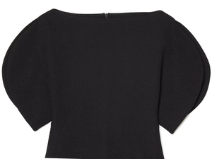 Detail of black puff sleeve top featuring an invisible back zipper and elegant off-shoulder cut