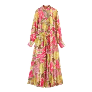 Detailed view of floral chiffon dress featuring V-neck ties and pleated skirt hem
