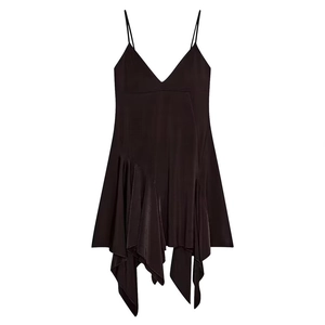 Detail view of smooth black satin fabric with an irregular draped hem on the dress