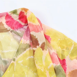Detail of floral chiffon dress neckline with artistic abstract print and tie strings