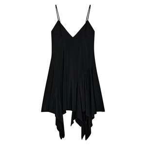 Close-up of asymmetrical pleated hem and sleek black satin fabric of the mini dress