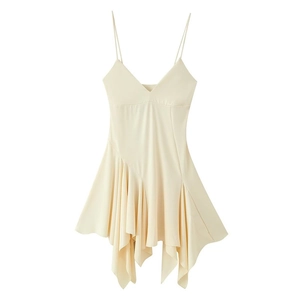 Detail of asymmetrical ruffled hem and layered drapes on cream cocktail dress
