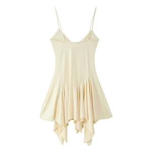 Detail of cream asymmetrical dress featuring layered ruffled hem and sleek spaghetti straps
