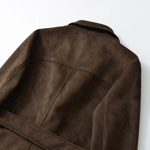 Close-up of dark brown faux suede blazer back with elegant stitching and fine texture