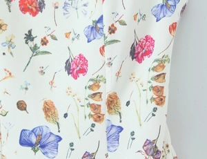 Close-up of vibrant floral print on white fabric with high-quality vertical stitching detail