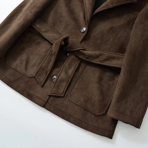 Detailed view of dark brown faux suede blazer with textured fabric and tie waist belt
